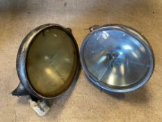 A large pair of Lucas headlamps, possibly P100s.