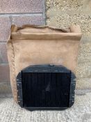 A new old stock Ford Escort radiator in original packaging.