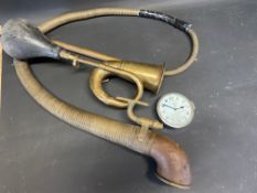 An eight day car clock, a brass boa constrictor partial horn and one other.