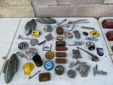 A selection of assorted car badges, insignia, spark plugs in tins including Igna etc.