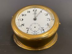 A large Edwardian brass sloping backed eight day car clock.