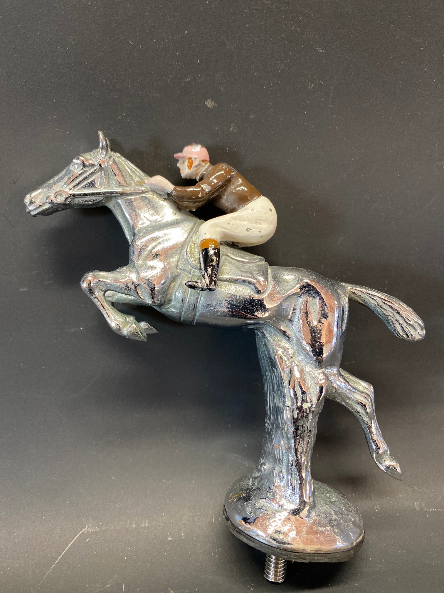 A Desmo style accessory car mascot in the form of a horse and jockey.