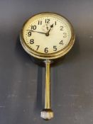 A brass eight day car clock with secondary dial and bottom wind.