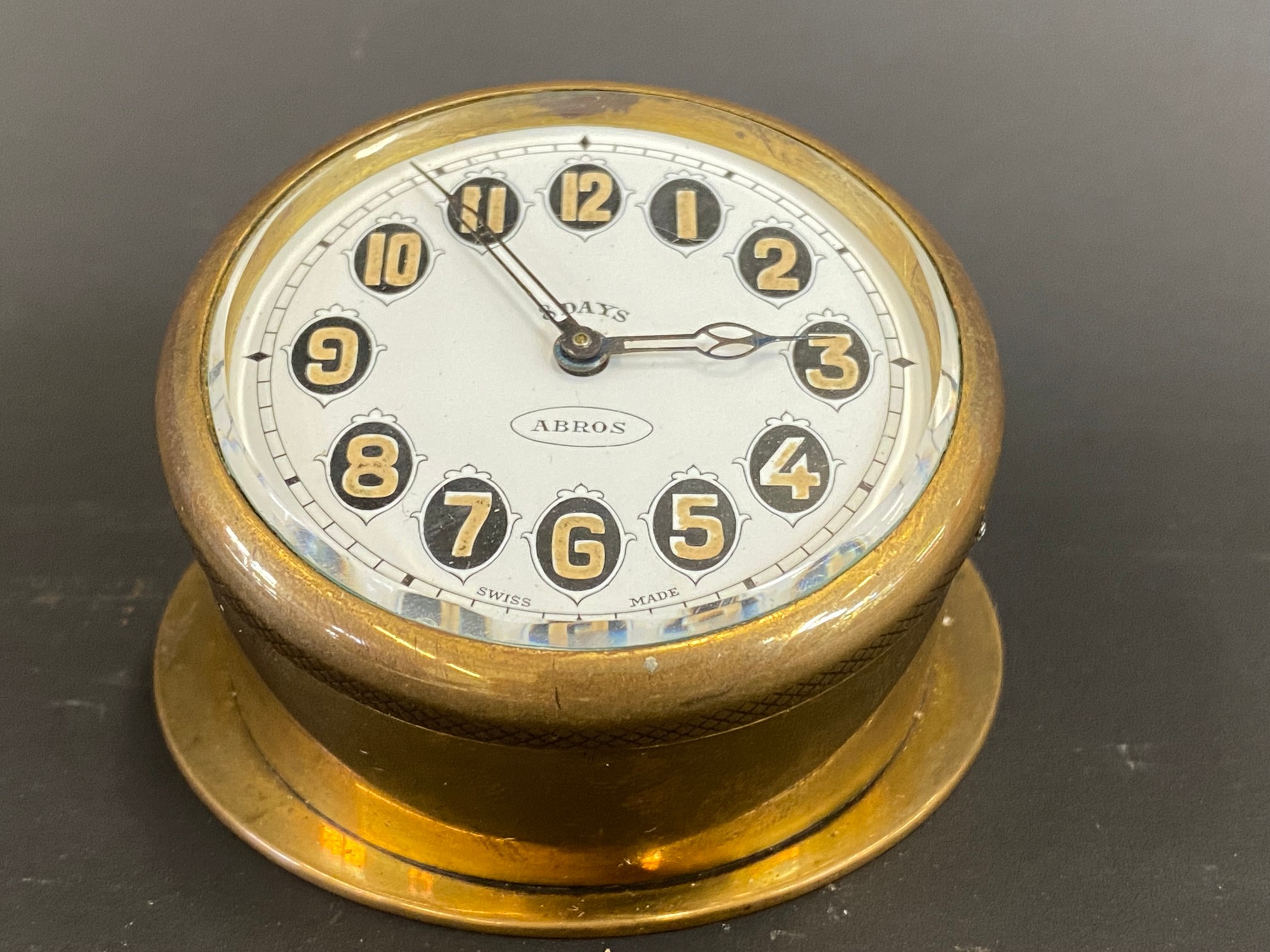 An Edwardian brass sloping backed eight day car clock.