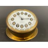 An Edwardian brass sloping backed eight day car clock.