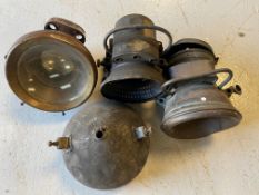 Four pre-war headlights including an H & B self-generating lamp.