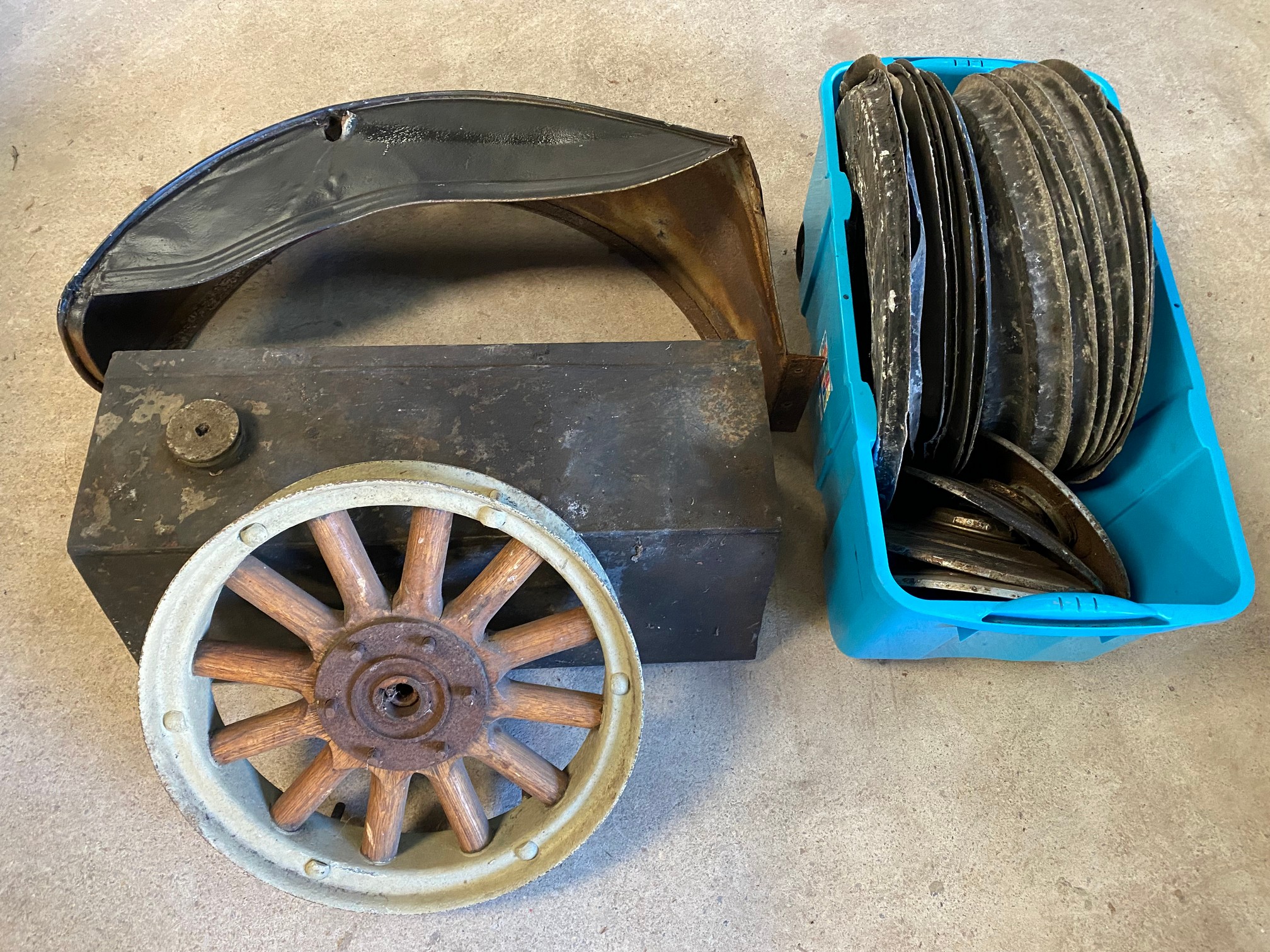 An autojumbler's lot of various early parts including a rear mudguard, hickory wheel etc.