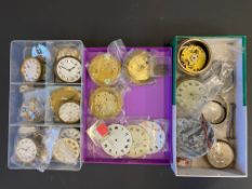 Three small trays of car clock parts.