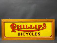 A Phillips Bicycles glass advertising sign, framed for display, 32 x 12 1/2".