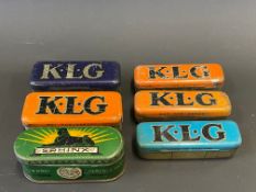 Six KLG and Sphinx spark plug tins, four with contents.