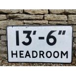 A metal road sign warning of a 13ft 6" head room limitation.