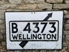 A cast metal road sign for the B4373 to Wellington, with glass reflectors to the letters, mostly