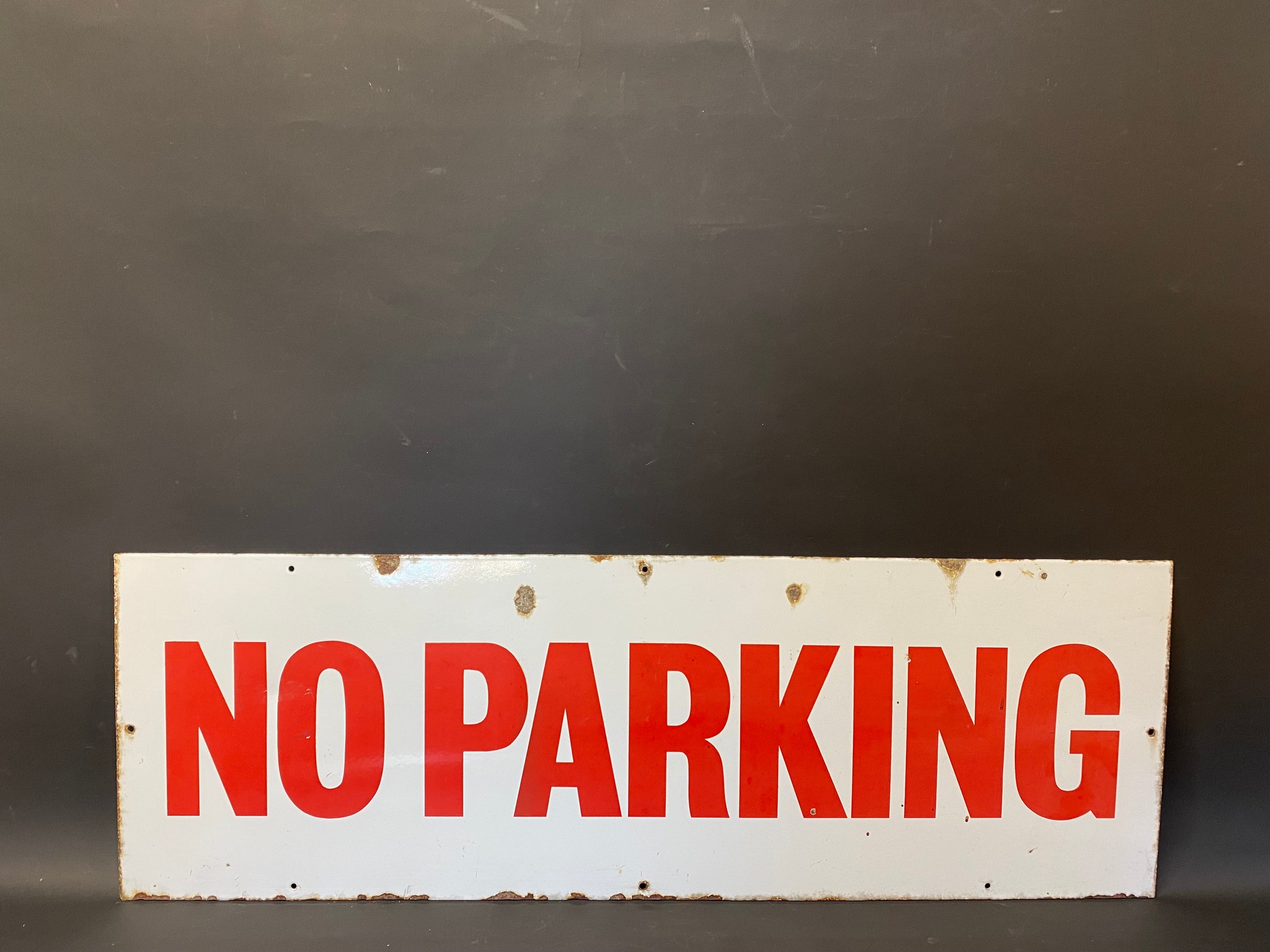 A rectangular No Parking enamel sign, 36 x 12".