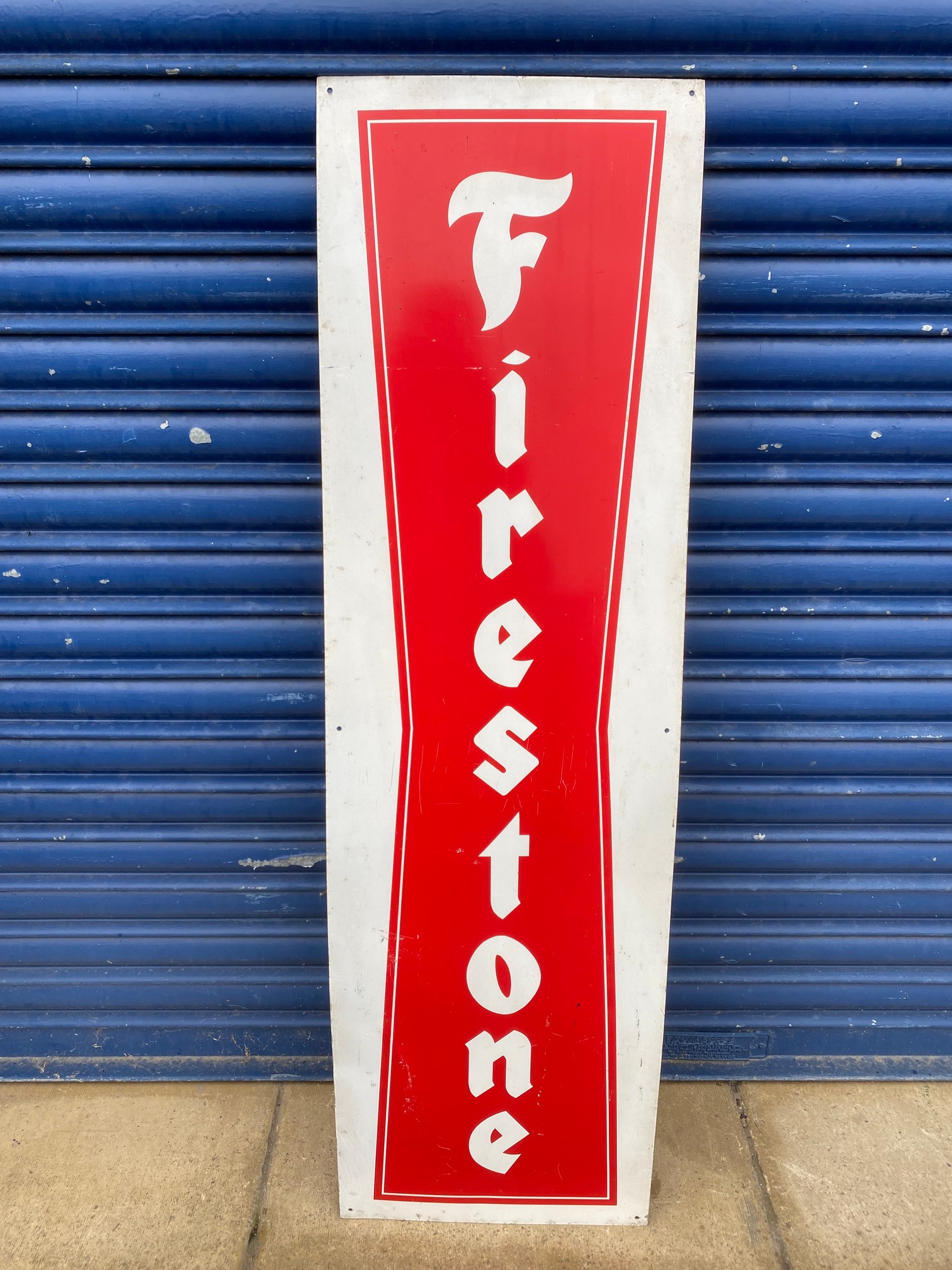 A Firestone tin advertising sign, 14 x 48".