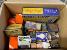 A box of assorted car bulbs in original packaging plus an Endura Lamps rectangular tin.