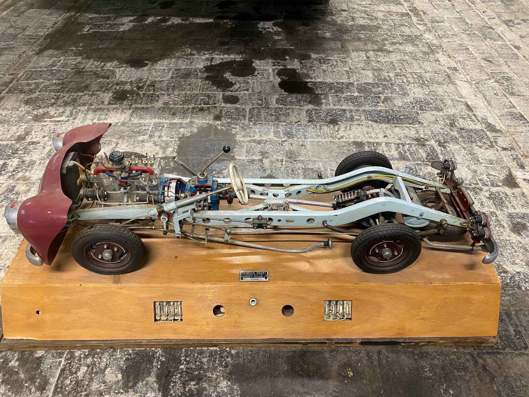 A German cut-away educational scale model of a commercial vehicle chassis, electrified for