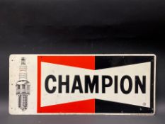 A Champion Spark Plugs tin advertising sign, 23 x 9 1/2".