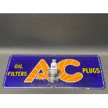 An AC Oil Filters and Plugs rectangular enamel sign, 21 x 9".