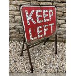 A Keep Left warning sign with integral glass reflectors, mounted in a freestanding frame.