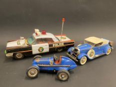 A Schuco clockwork tinplate model of a Mercedes Benz racing car, a Japanese tinplate model of an