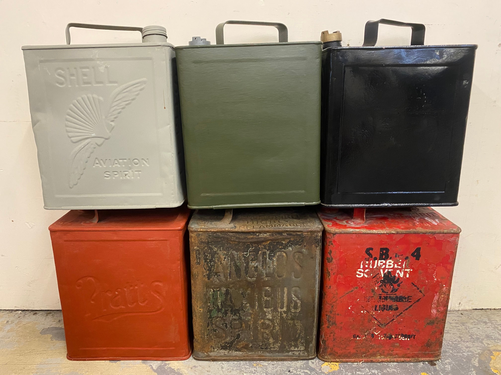 Six two-gallon petrol cans including Anglo's Taxibus Spirit.