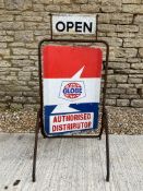 A garage forecourt open/closed spinning sign with advertising for Globe petrol.