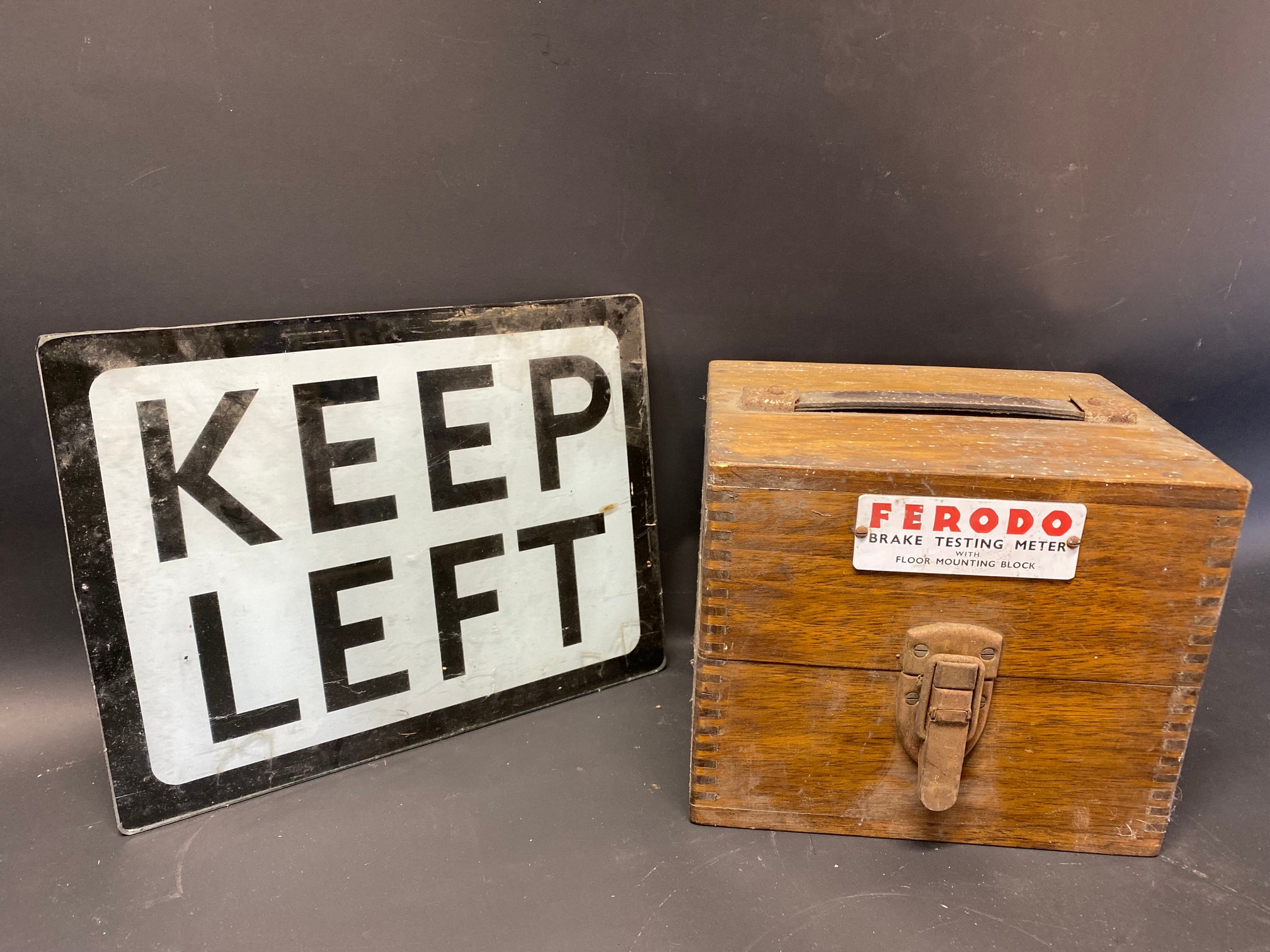 A Ferodo Brake Testing Meter empty box and a glass Keep Left illuminated bollard insert.