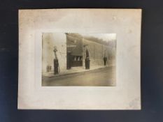 A very early photograph of a row of three kerbside petrol pumps, one with a rarely seen Pratts