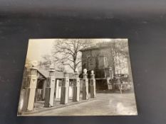 A fabulous period photograph of a garage forecourt, six petrol pumps serving different brands of