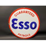 An Esso Guaranteed Petrols circular enamel sign, cut from a larger sign, 25 1/2" diameter.