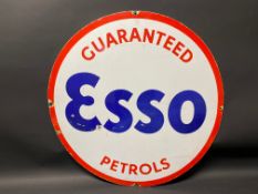 An Esso Guaranteed Petrols circular enamel sign, cut from a larger sign, 25 1/2" diameter.