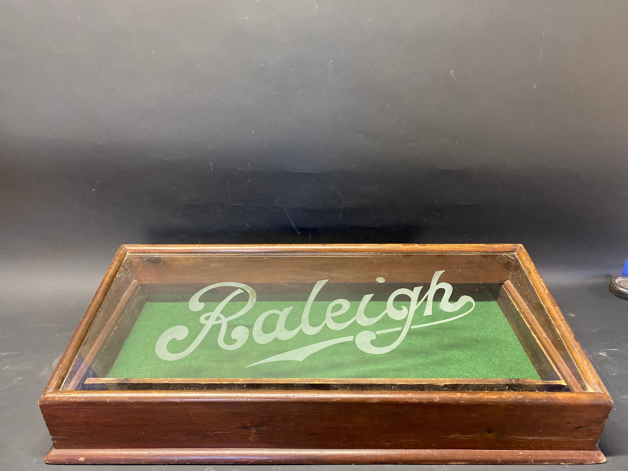 A mahogany cased Raleigh counter top sloping fronted dispensing cabinet with etched lettering to the