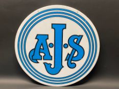 An AJS circular plastic showroom advertising sign, 17 3/4" diameter.