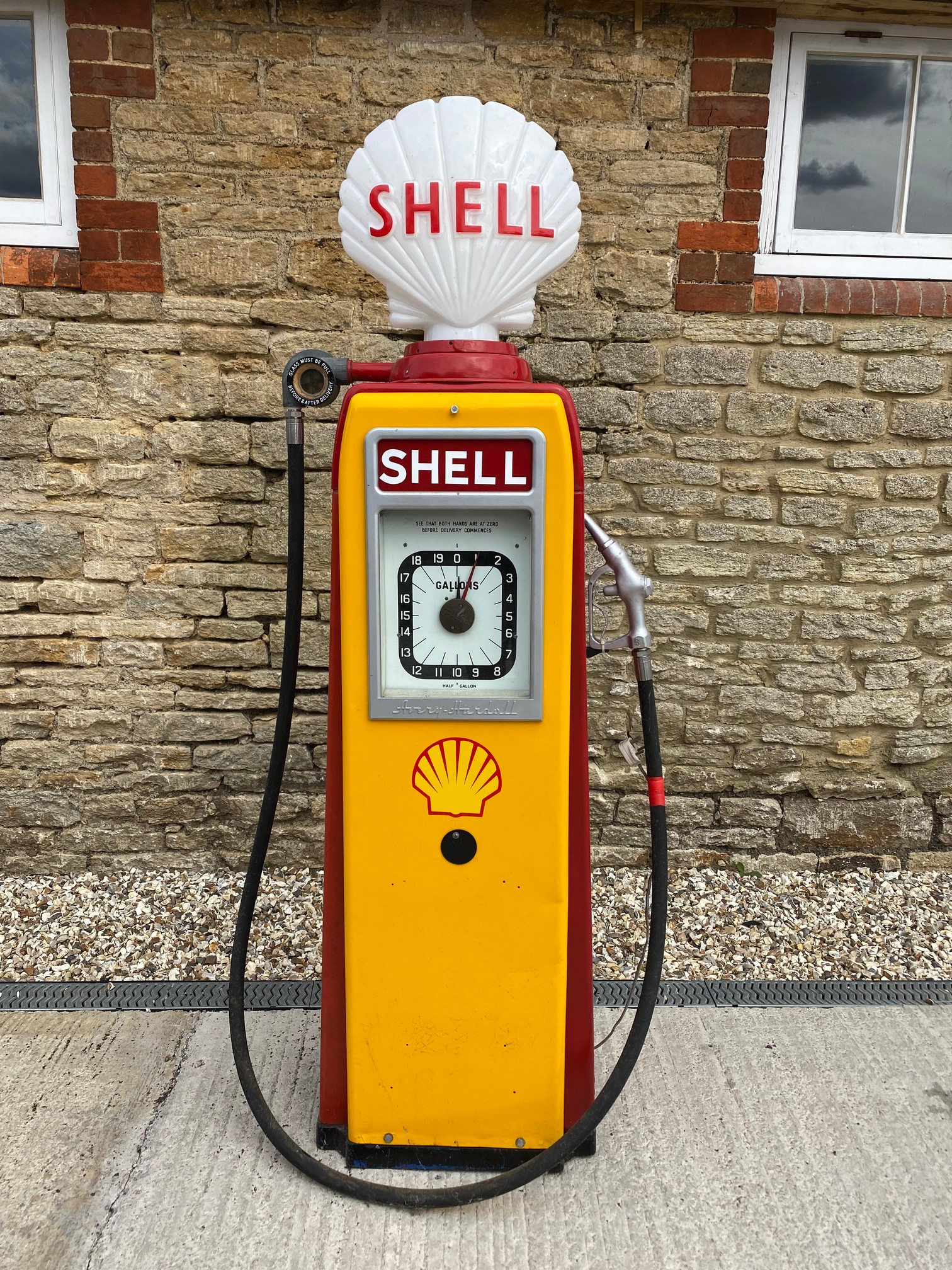 An Avery Hardoll electric petrol pump restored in Shell livery, with reproduction Shell globe,