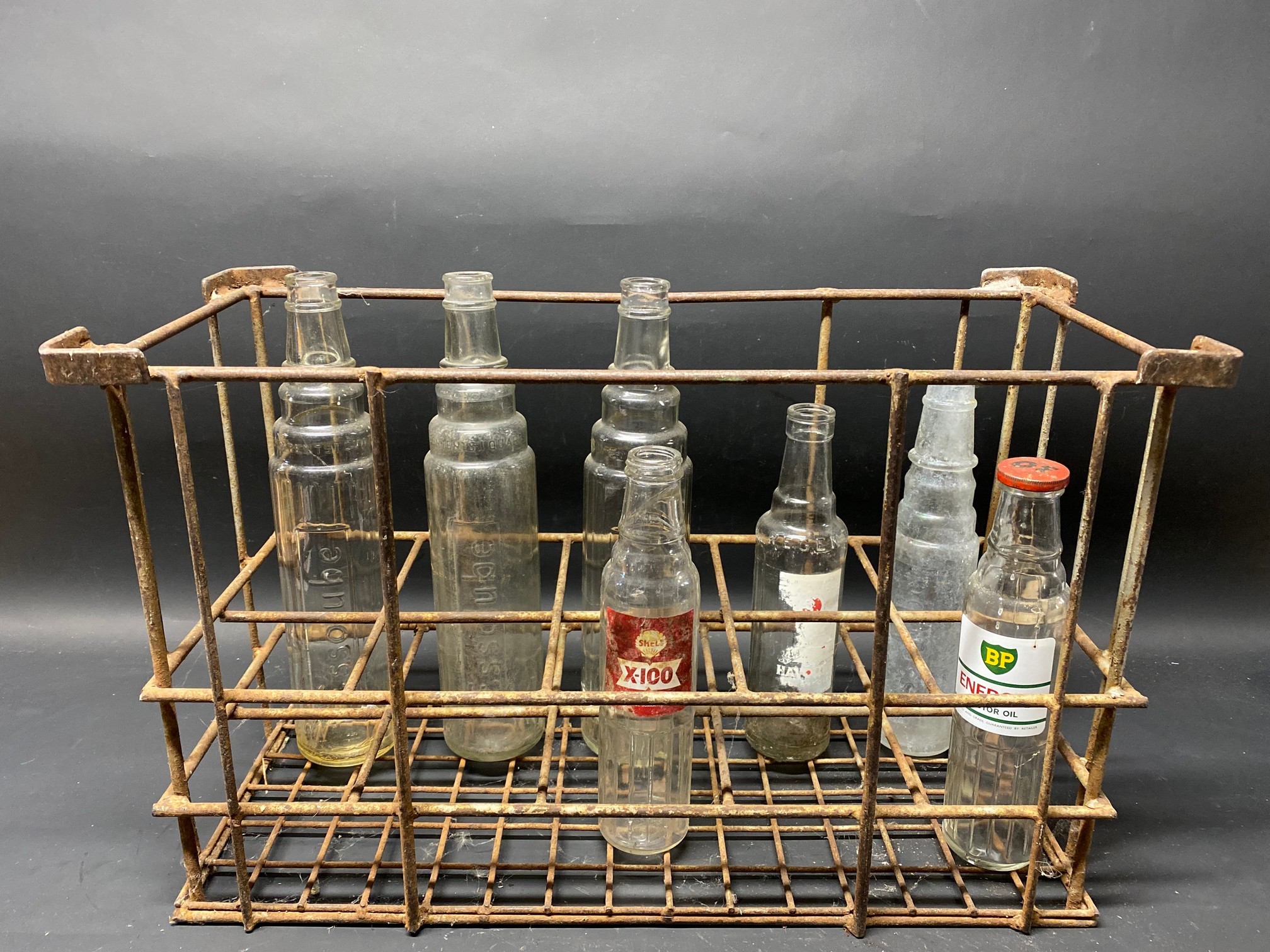 A 10 division oil bottle crate containing an assortment of oil bottles.
