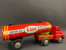 A tinplate model of an Esso articulated tanker, with plastic cab, in good condition.