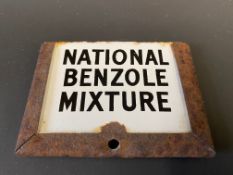 A small National Benzole Mixture enamel brand indicator plaque in metal holder.