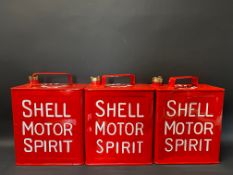 Three very well restored Shell Motor Spirit two gallon petrol cans, two with Shell caps.