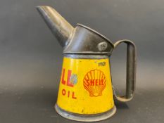 A Shell Motor Oil pint measure of bright colour.