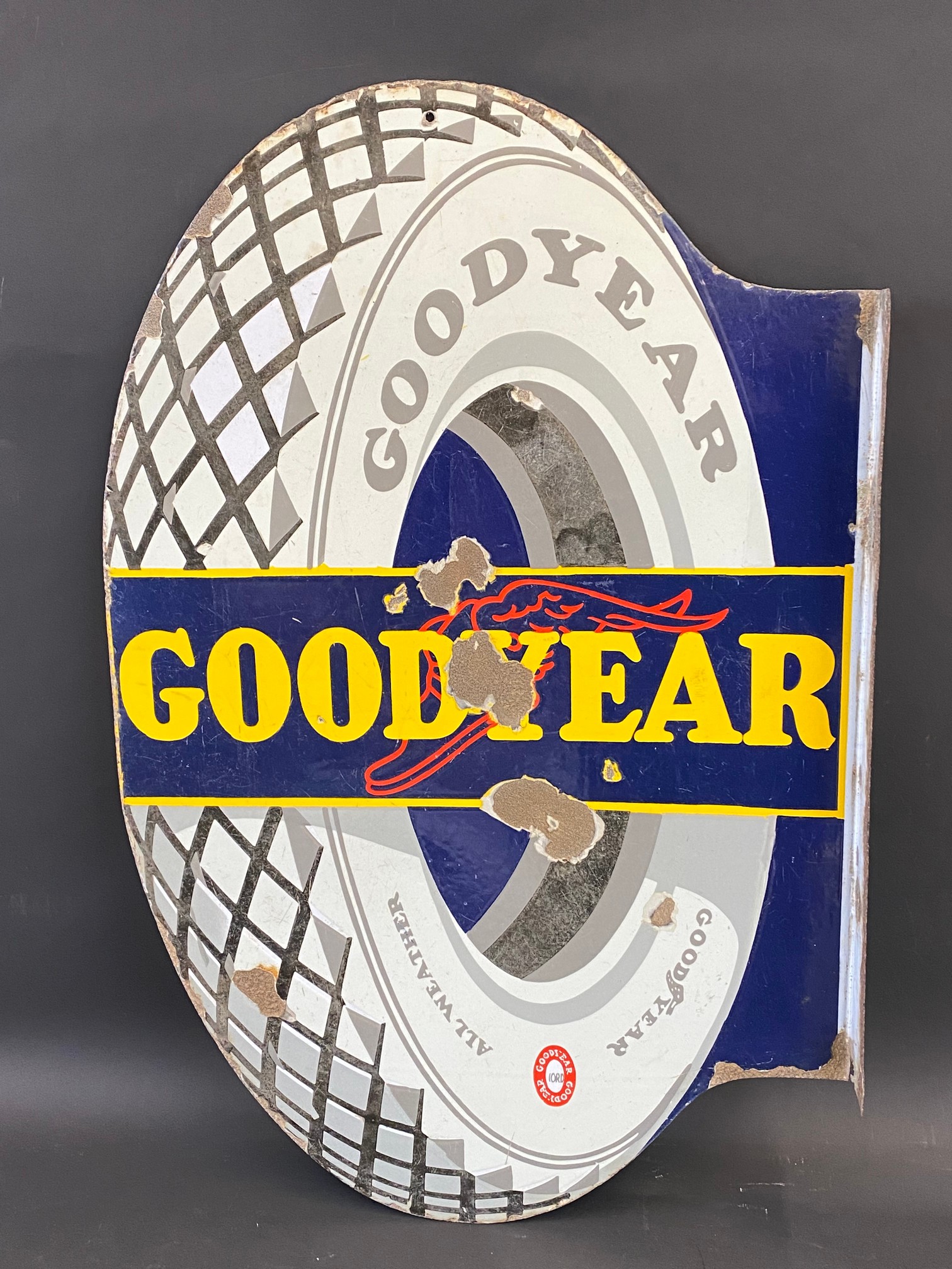 A Continental Goodyear tyre-shaped double sided enamel sign with hanging flange, 22 x 34".