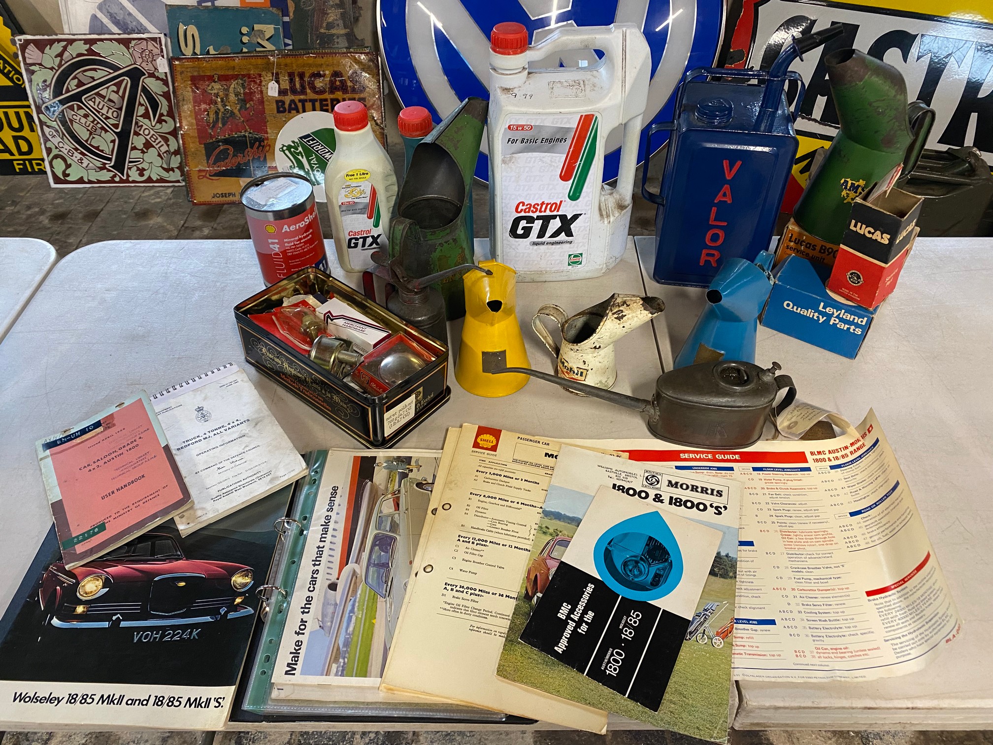 A selection of assorted oil measures and car related memorabilia.