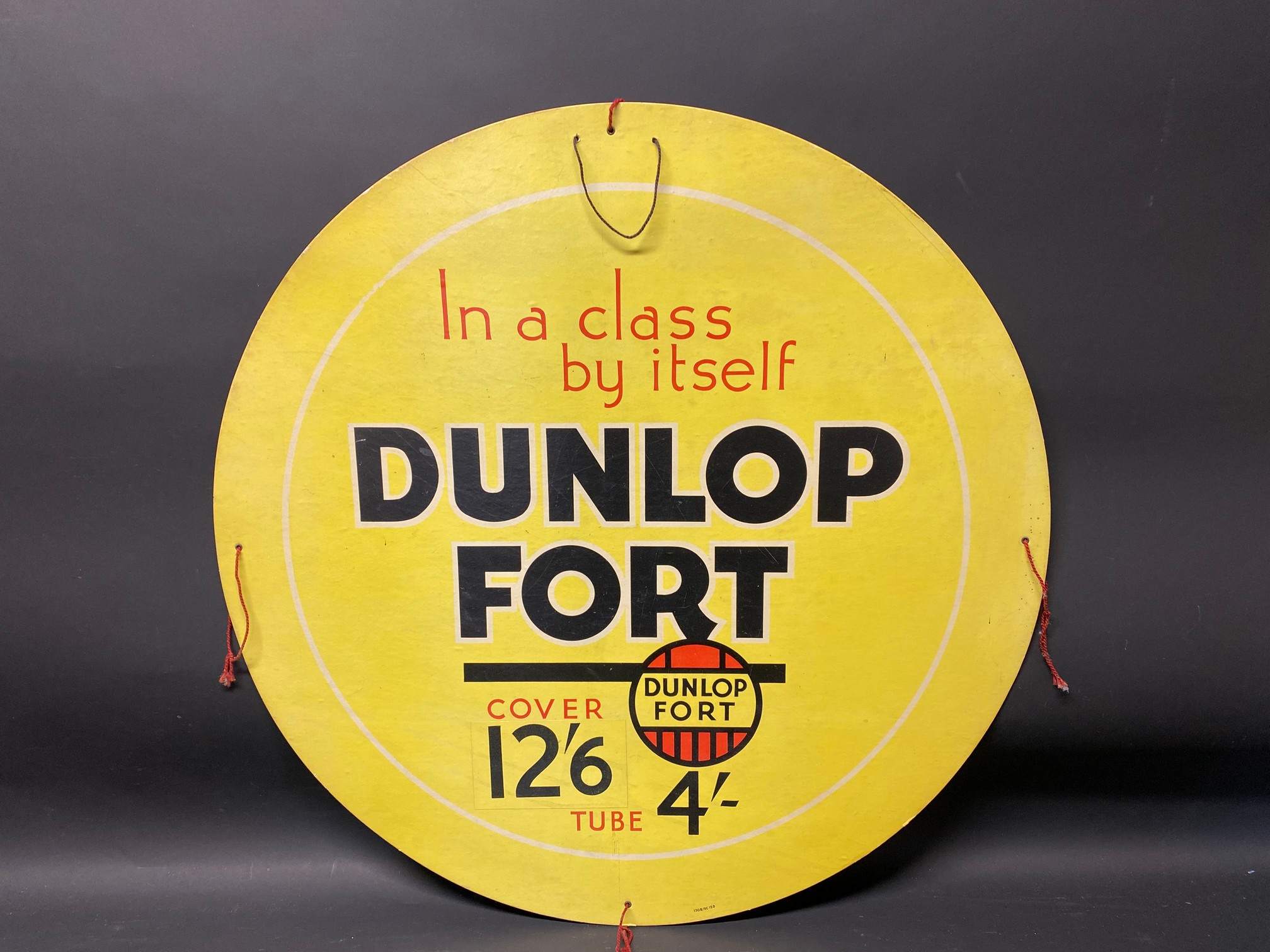 A Dunlop Fort circular cardboard advertising sign, 26" diameter.