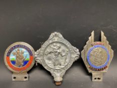 Three different version St. Christopher car badges.