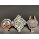 Three different version St. Christopher car badges.