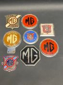 A collection of MG Car Club badges.