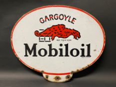 A Gargoyle Mobiloil double sided enamel advertising pediment sign from an oil cabinet.