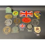 A tray of mixed car badges, rally plaques etc.