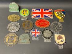 A tray of mixed car badges, rally plaques etc.