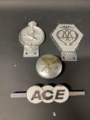 An AA commercial badge, a Lucas car badge, an ACE badge and an oil cap.