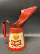 A Shell X-100 Motor Oil quart measure.